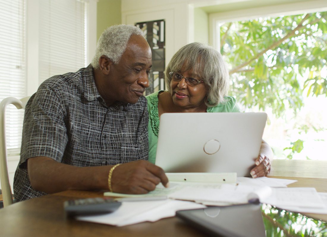 Medicare - Senior Couple Looking at Medicare Options Together at Home