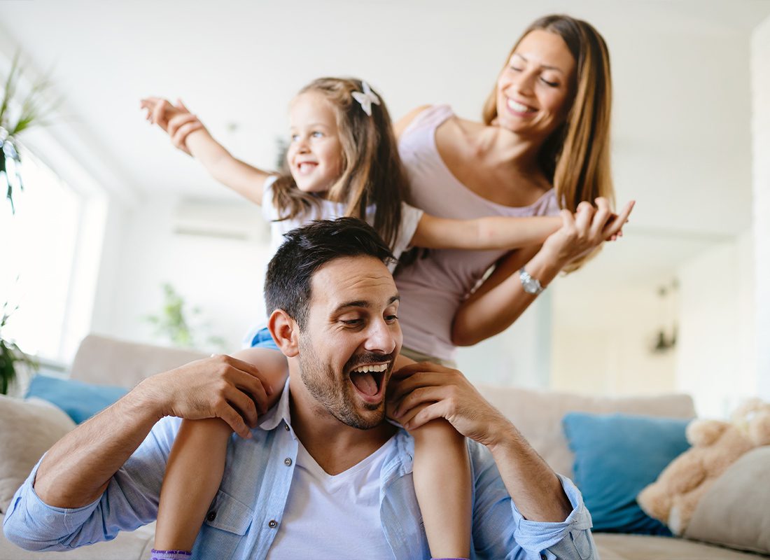 Personal Insurance - Young Family Spending Time and Having Fun Together in Their Living Room